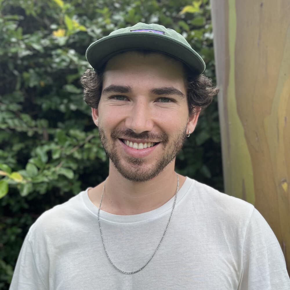 Iván González, co-founder and architect at Materia Studio, smiling outdoors.